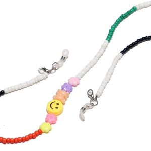Detail of colorful beaded glasses chain with cute bear, flower, and smiley face charms