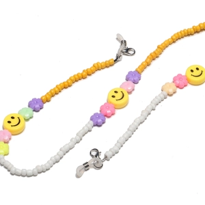 Detail of colorful beaded eyewear chain with smiley faces and macaron flower beads