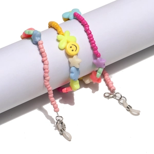 Detailed view of colorful beaded eyewear chains with smiling face and flower charms
