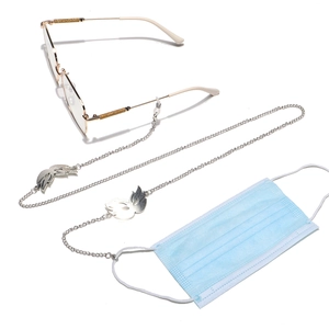 Detail of silver eyewear chain featuring swan charms with silicone loops and lobster clasps