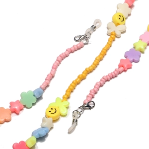Detail of colorful beaded glasses chain with smiley faces, stars, and flowers