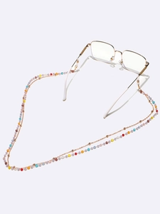 Detail of colorful crystal beads on eyeglasses chain with gold metal spacers and silicone loops