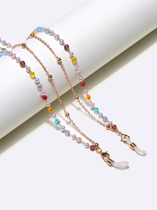 Detail of colorful crystal beads and faux pearls on a double-layer eyewear chain
