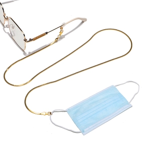 Detailed view of golden metal chain used as a glasses holder and face mask lanyard