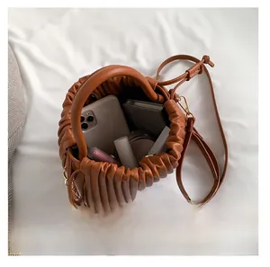 Top view of caramel pleated bucket bag showing spacious interior for daily essentials