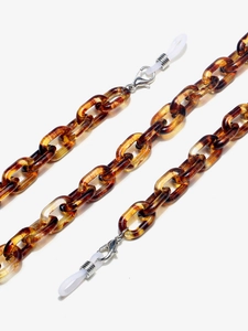 Detailed close-up of tortoise shell resin eyeglass chain with silver lobster clasps