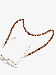 Detail of leopard print acrylic eyewear chain with silicone ends on metal glasses