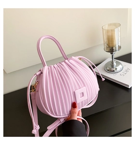 Detail view of lavender pleated bucket bag with square buckle and detachable strap