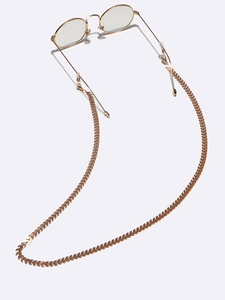 Detail of golden arrow link eyeglass chain with clear silicone loops on gold glasses