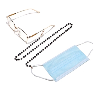 Detail of beaded black glasses chain and mask strap with gold links and secure metal hooks