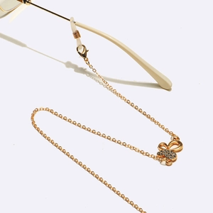 Gold punk eyewear chain featuring a rhinestone butterfly pendant and non-slip loops