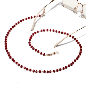 Detail of red crystal beaded eyewear chain with gold lobster clasp and silicone loops