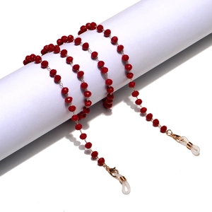 Close-up of red faceted crystal beads on eyeglass chain with golden lobster clasps