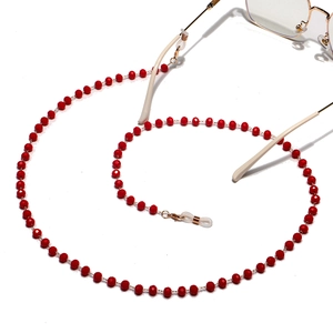 Detail of red crystal faceted beads glasses chain with golden non-slip rubber loops