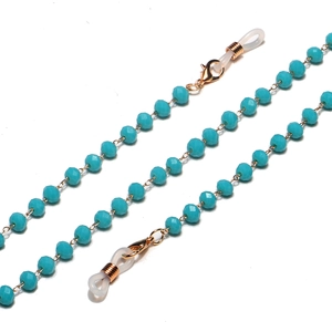 Macro view of blue beaded eyeglass chain with gold metal rings and lobster clasps