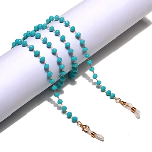 Close-up of blue faceted crystal bead glasses chain with gold lobster clasp and loops