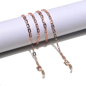 Detail of rose gold rectangular link chain with lobster clasp and silicone loop