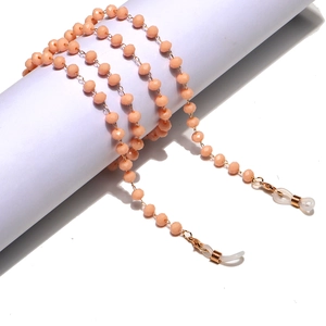Detail of peach pink crystal beaded glasses chain with golden links and silicone loops