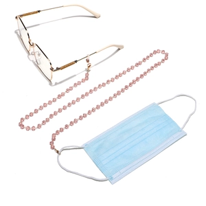 Detail of pink crystal beaded glasses chain with gold lobster clasps on white background