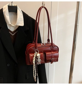 Deep red faux leather shoulder bag with pockets and cute bear charm detail