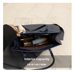 Spacious interior of denim tote bag showing sunblock, perfume and makeup items