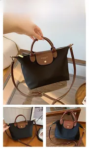 Detail of oxford nylon tote with brown leather handles and adjustable shoulder strap