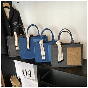 Detail of multi-color minimalist canvas tote bags featuring stylish ribbon pendants