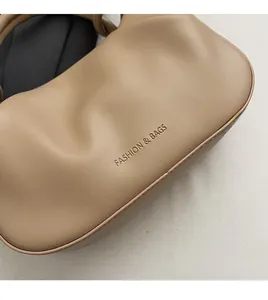 Detail of soft beige pleated bucket bag texture with Fashion & Bags lettering