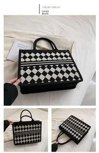 Detail view of large black and white checkered canvas tote bag with woven texture