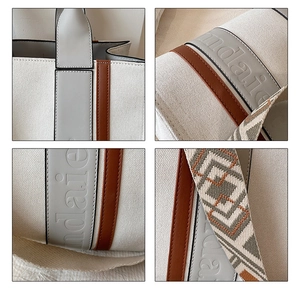 Détails du sac cabas en toile avec finitions cuir, logo embossé et bandoulière jacquard