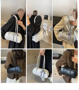 Detailed views of the ribbon bow ballet-style Boston bag in white silver and black