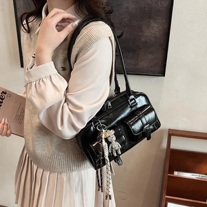 Retro black shiny leather multi-pocket shoulder bag with metallic details and charms