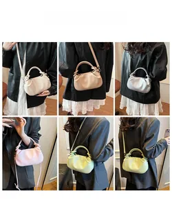 Detail shot of pleated cloud handbags in multiple colors featuring soft PU leather texture