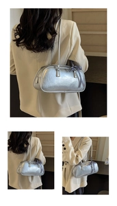 Detail of silver metallic handbag with bow ribbon and slim shoulder strap