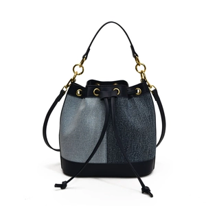 Patchwork denim bucket bag with blue tones and black leather trim for women