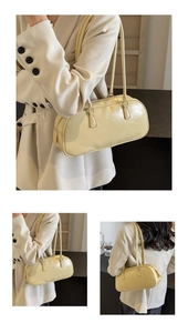 Detail of cream-colored ballet-style bow handbag with glossy wrinkled texture and dual straps