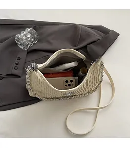 Top view of cream ruched croissant bag showing spacious interior with daily essentials