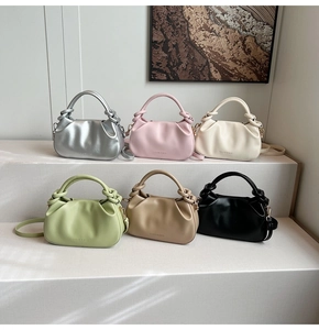 Close-up of pleated bucket bags in six colors with knotted handle and shoulder straps