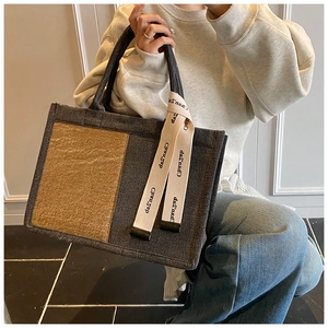 Detail of canvas tote bag showing two-tone contrast and ChuanZao branded strap detail