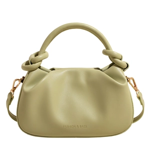 Olive green pleated bucket bag with knot handle and adjustable shoulder strap on white base