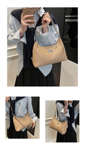Close-up of pleated beige shoulder bag with silver chain strap and metal turn-lock detail