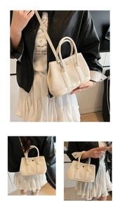 Close-up of pleated beige bucket bag with vertical texture and metal buckle detail