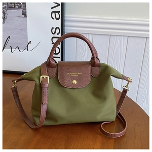 Olive green nylon tote bag with brown leather handles and adjustable shoulder strap details