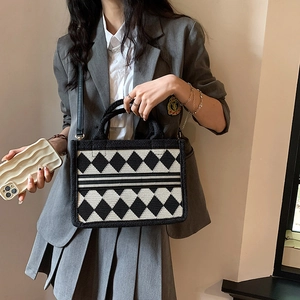 Classic black and white argyle tote bag with top handles and adjustable leather shoulder strap