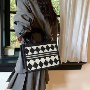 Classic argyle pattern tote bag with wide straps shown in a minimalist indoor setting