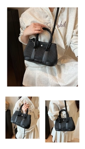 Detail view of black pleated bucket bag with dual handles and silver metal hardware