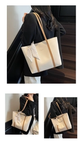 Detail of cream leather tote bag featuring a checkered scarf and brand logo lettering