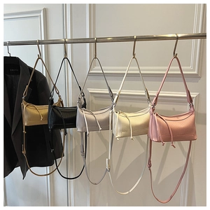 Close-up of pleated dumpling bags in five colors with knot pendants and shoulder straps