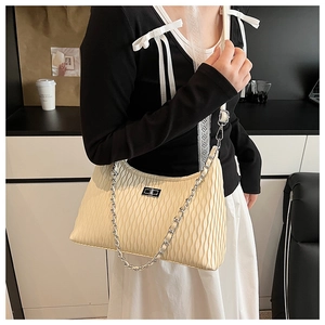 Detail of off-white ripple texture shoulder bag with silver metal twist lock and chain strap