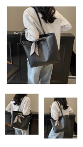 Detail of black tote bag with matte leather finish and houndstooth scarf accent